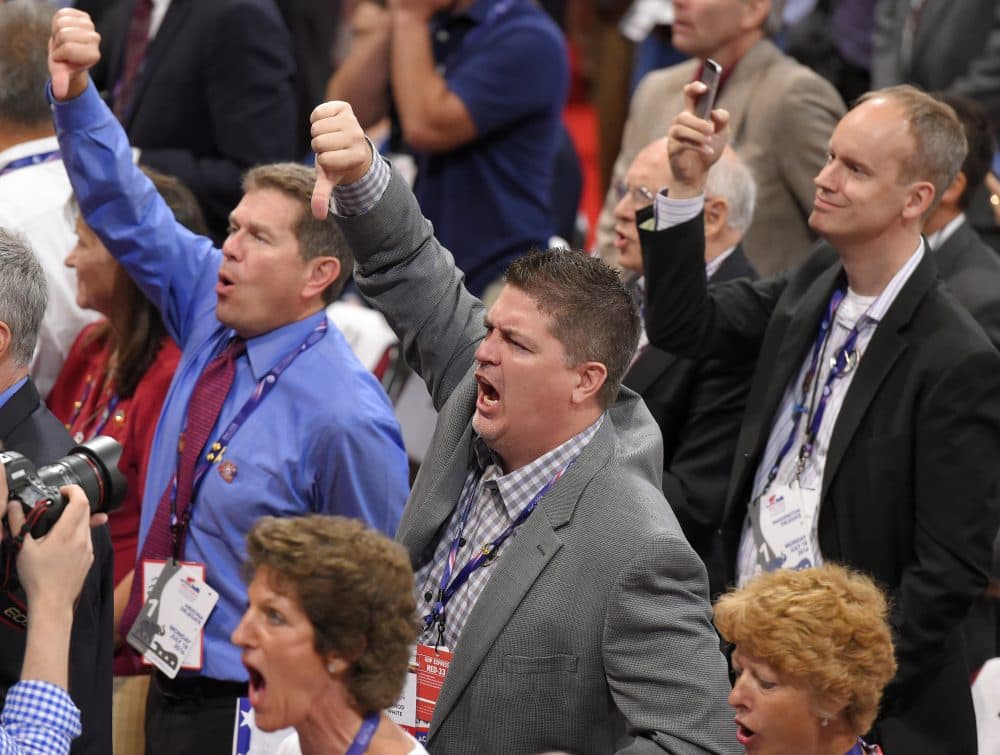 Delegates react as some call for a roll call vote on the adoption of the rules during the opening day of the Republican National Convention in Cleveland, Monday. (Mark J. Terrill/AP)