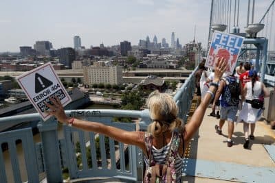 Demonstrators make their way to downtown on the Benjamin Franklin Bridge on Monday in Philadelphia, during the first day of the Democratic National Convention. (Alex Brandon/AP)