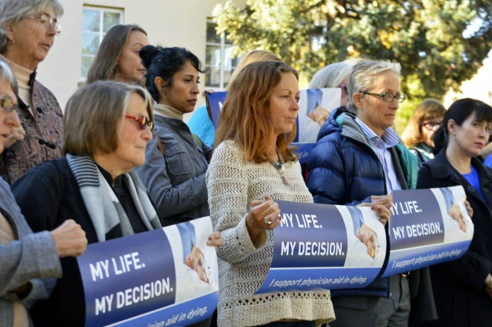 In this Oct. 26, 2015, file photo, right to die advocates rally outside the New Mexico Supreme Court in Santa Fe, N.M., after a lawyer asked justices to allow terminally ill patients to end their lives. (Russell Contreras/AP)
