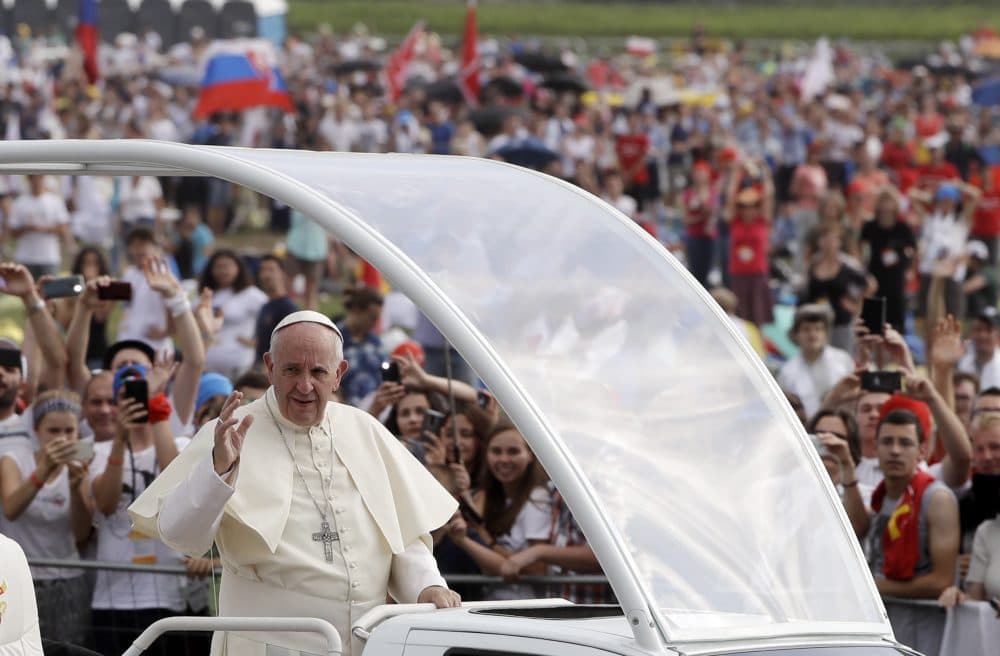 Pope Francis followed by a security guard arrives to celebrate a mass at conclusion of the World Youth Day in Krakow, Poland on July 31. (Gregorio Borgia/AP)