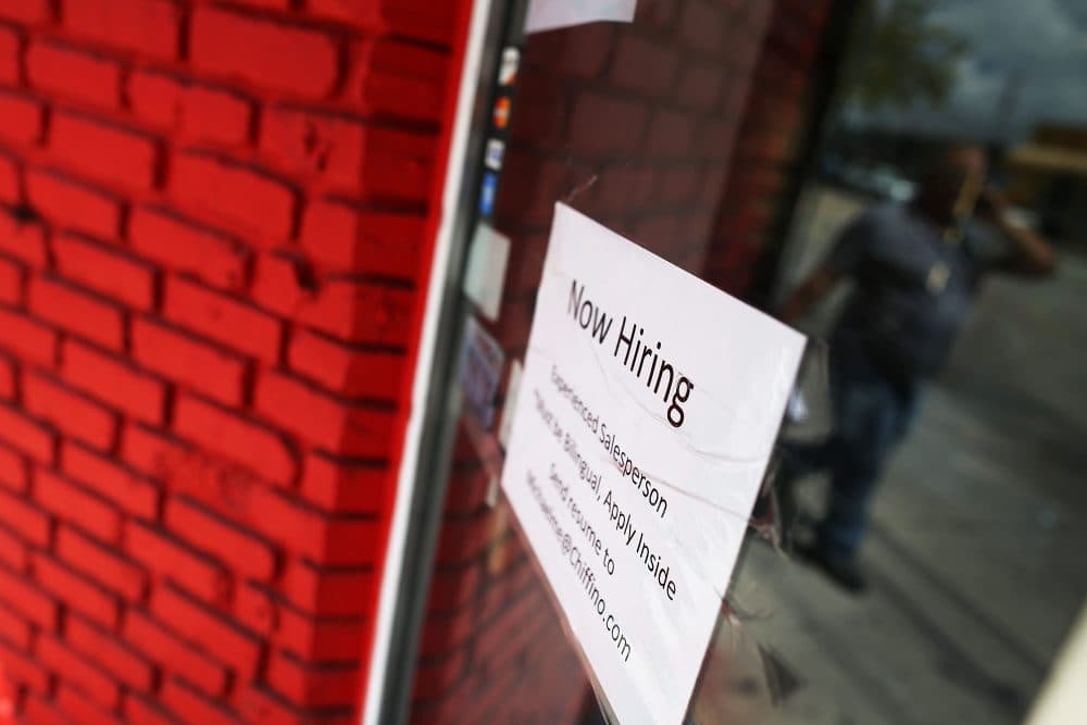 A now hiring sign is seen in the window of a business on April 1, 2016 in Miami, Florida. (Joe Raedle/Getty Images)