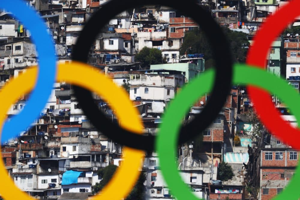 The Olympic Rings are seen with favelas in the background at the Sambodromo on Aug. 6, 2016 in Rio de Janeiro, Brazil. (Paul Gilham/Getty Images)