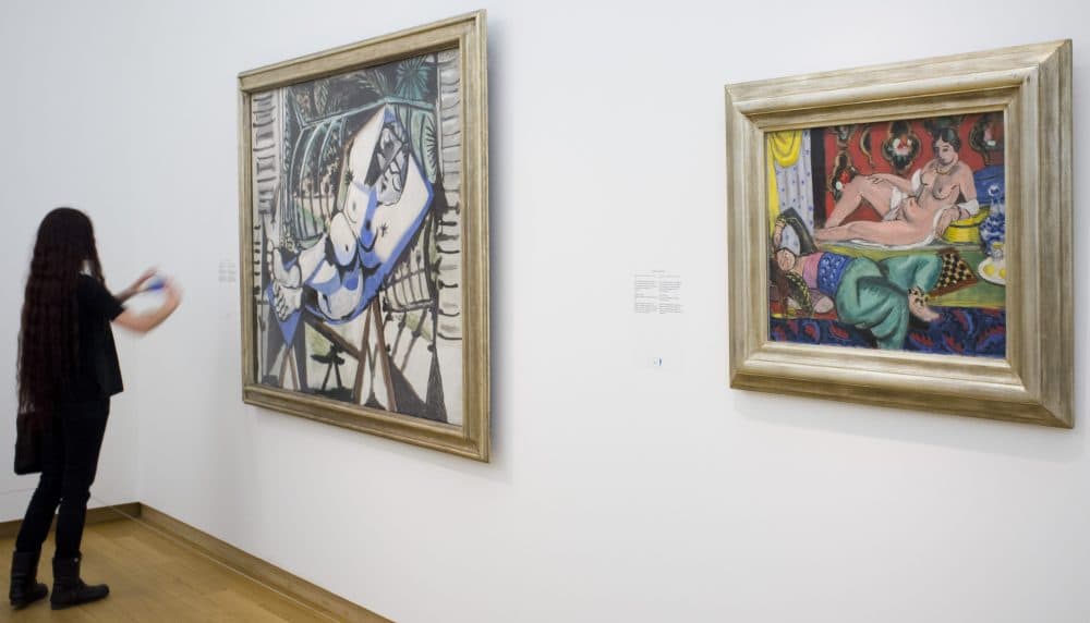 A woman takes a pictures of a painting titled &quot;Two Odalisques, One Undressed, Ornamental Background and Checkerboard&quot; dated 1928 by French artists Henri Matisse (1869-1954), right, next to a painting by Pablo Picasso titled &quot;Nude in front of a Garden,&quot; left, during a press preview of the exhibit &quot;The Oasis of Matisse&quot; at Stedelijk Museum in Amsterdam, Netherlands in 2015. (Peter Dejong/AP)