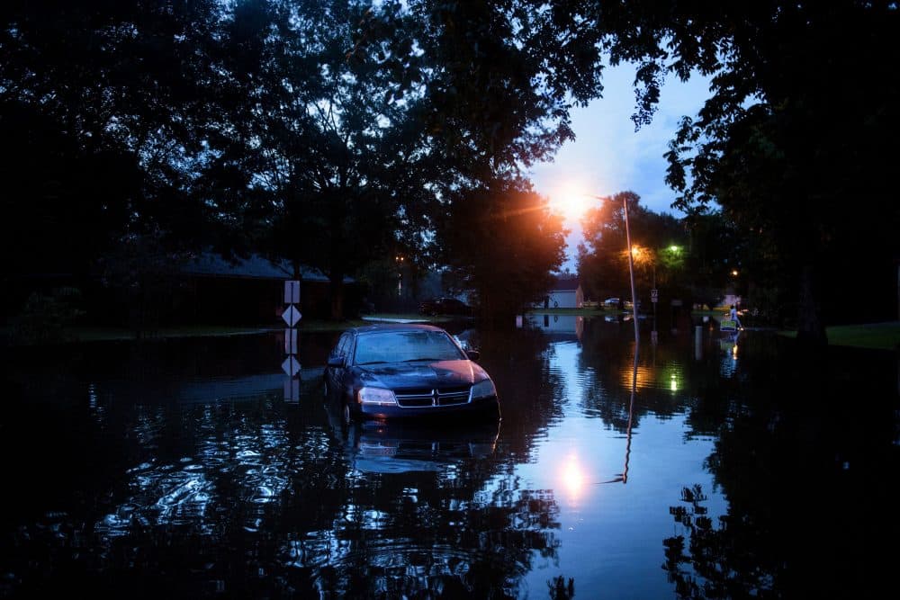 An abandoned car is seen in a flooded street on Aug. 15, 2016 in Baton Rouge, Louisiana. (Brendan Smialowski/AFP/Getty Images)