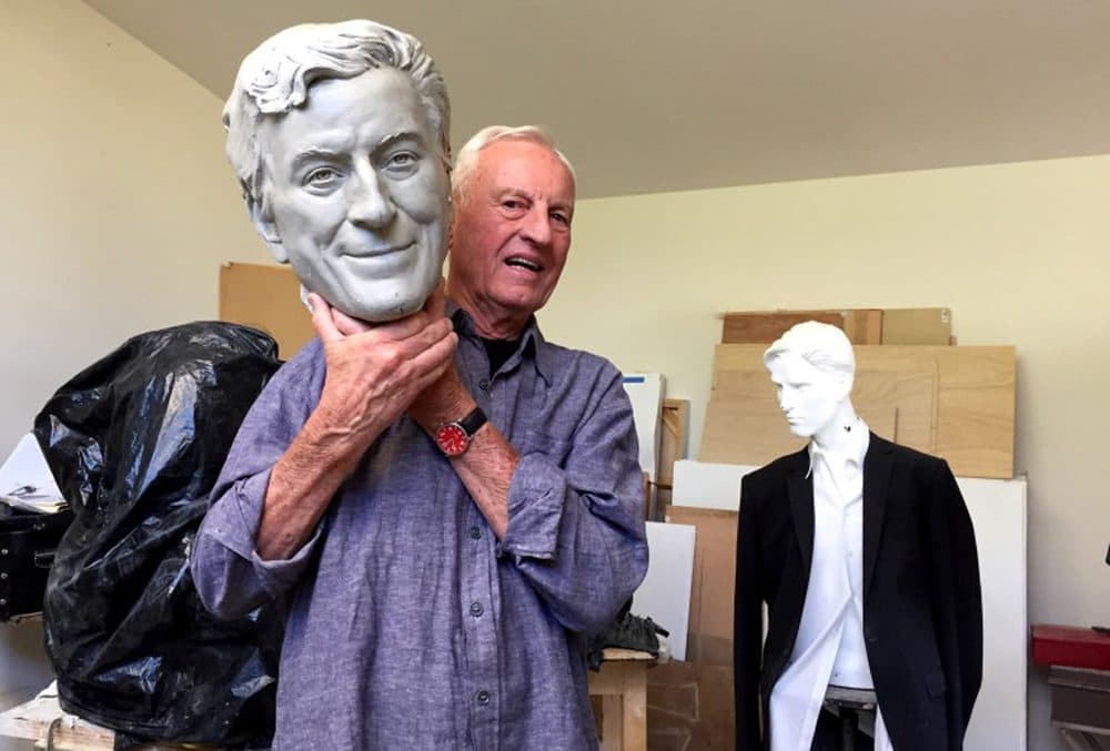 Sculptor Bruce Wolfe poses with the plaster cast of Tony Bennett’s head. (Cy Musiker/KQED)