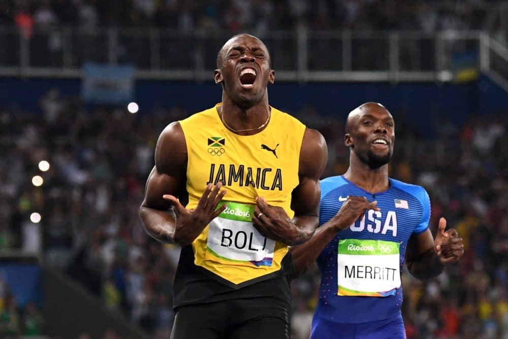 Jamaica's Usain Bolt (L) reacts asfter he crossed the finish line to win the Men's 200m Final during the athletics event at the Rio 2016 Olympic Games at the Olympic Stadium in Rio de Janeiro on Aug. 18, 2016. (Oliver Morin/AFP/Getty Images)