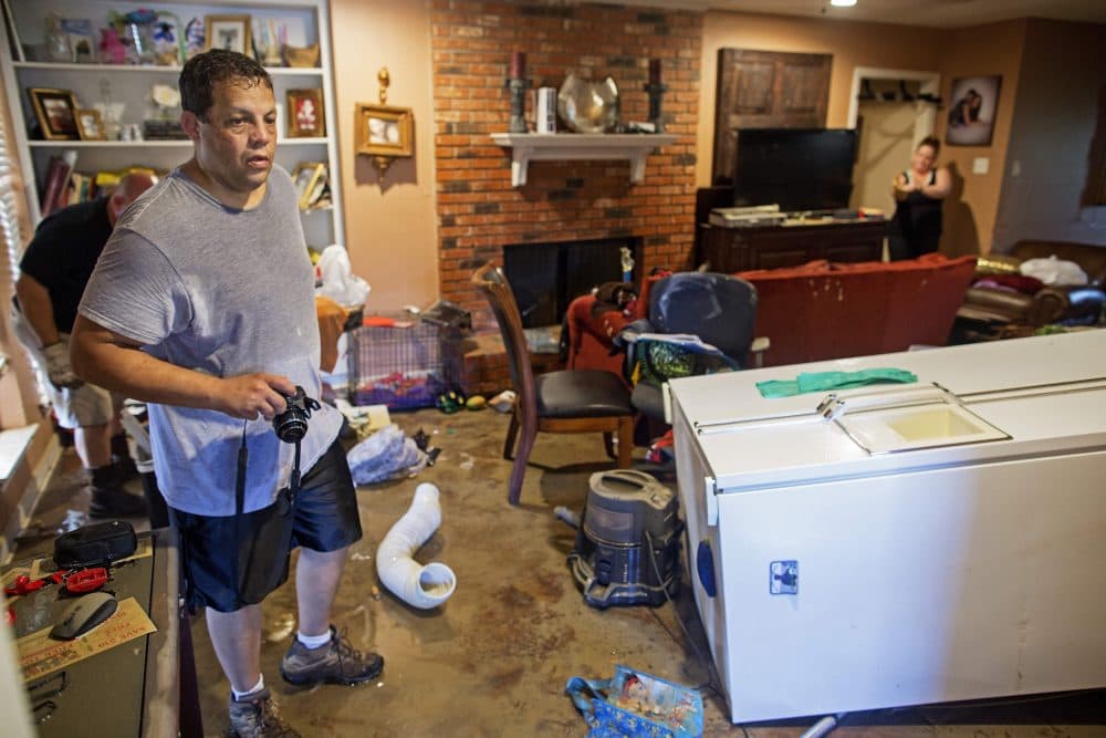 Raymond Lieteau takes photos his flood damaged home in Baton Rouge, La., Tuesday, Aug. 16, 2016. Lieteau had more than five feet of water in his home. (Max Becherer/AP)