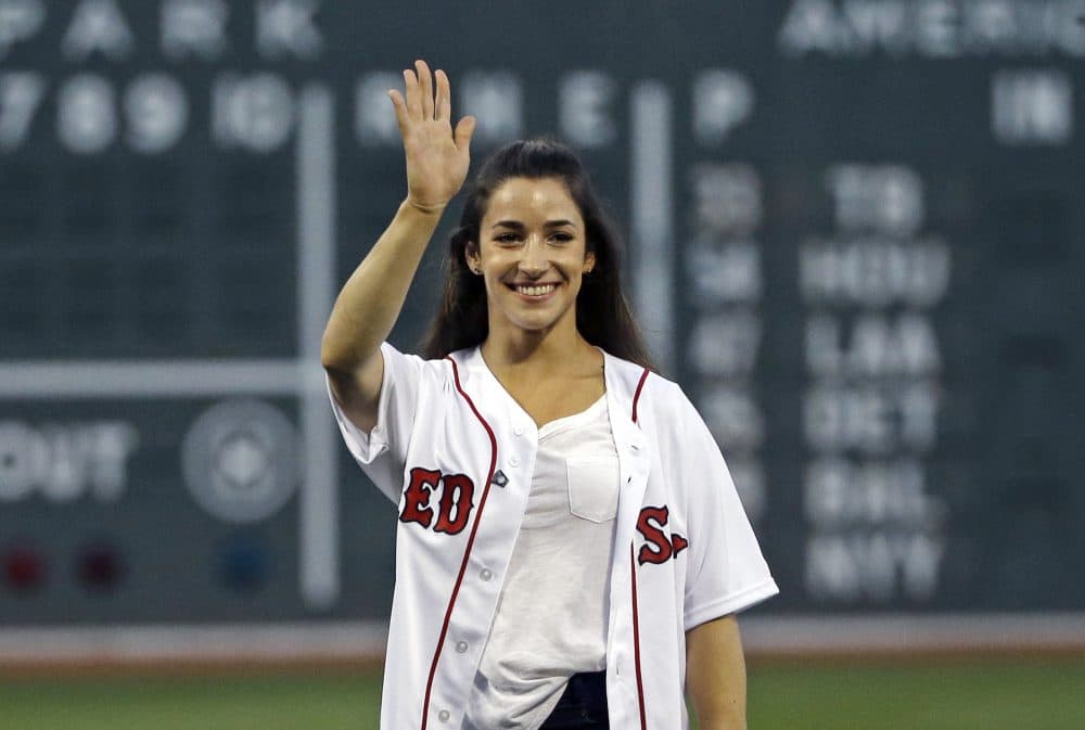 Olympic gold medalist Aly Raisman waves after throwing a ceremonial first pitch before a Red Sox game at Fenway Friday night. (Elise Amendola/AP)
