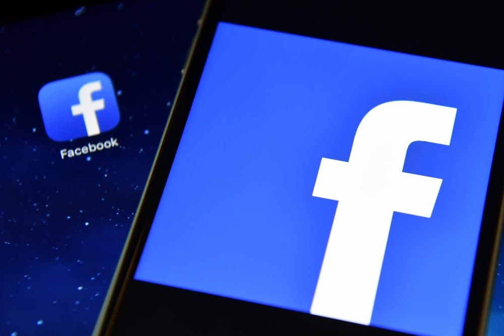 The Facebook app logo displayed on an iPad next to a picture of the Facebook logo on an iPhone. (Carl Court/Getty Images)
