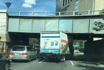 A large moving truck is stuck under an overpass on Storrow Drive. (Courtesy Massachusetts State Police)