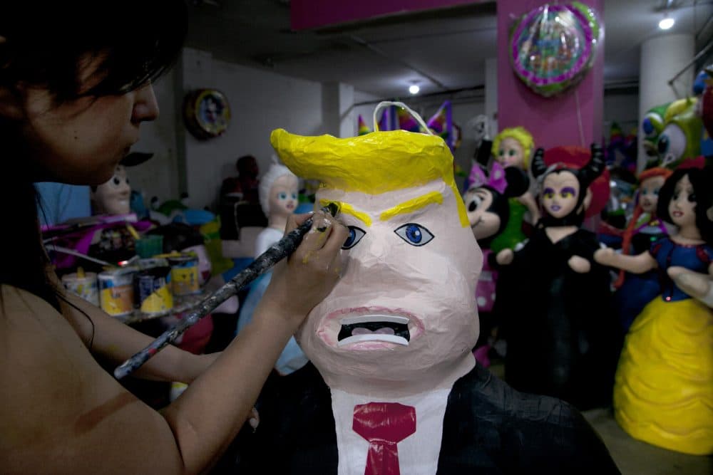 Alicia Lopez Fernandez paints a pinata depicting Donald Trump at her family's store &quot;Pinatas Mena Banbolinos&quot; in Mexico City. In a surprise move, Donald Trump will travel to Mexico on Wednesday, Aug. 31, to meet with President Enrique Pena Nieto, just hours before the Republican delivers a highly anticipated speech on immigration. (Marco Ugarte/AP)