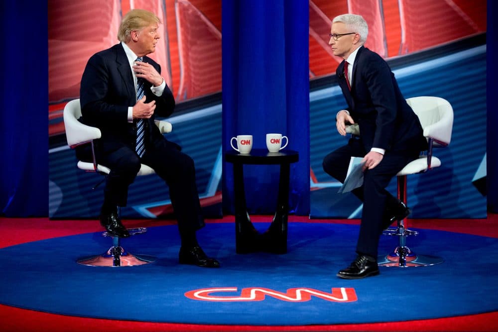 In this Feb. 18 file photo, Republican presidential candidate Donald Trump speaks with Anderson Cooper, right, during a commercial break at a CNN town hall. (Andrew Harnik/AP)
