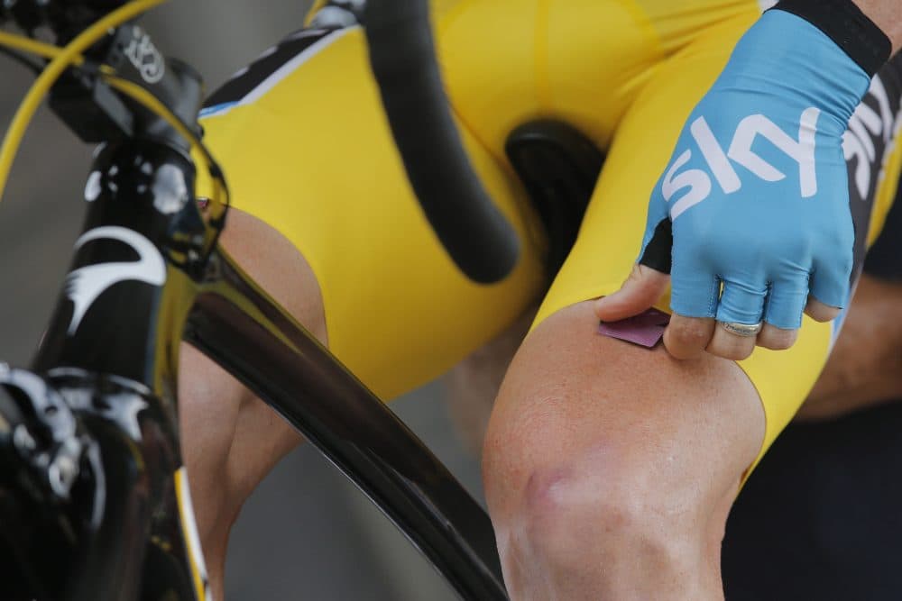 A biker puts an energy gel under his shorts prior to the start of the 17th stage of the Tour de France in 2013. (Christophe Ena/AP)
