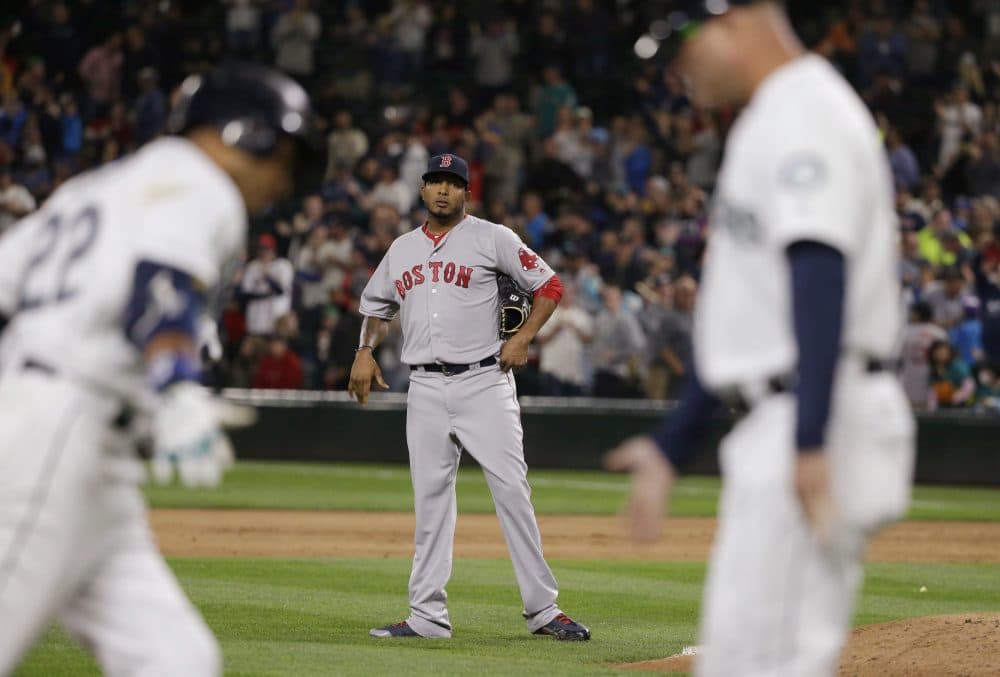 Boston Red Sox pitcher Fernando Abad watches as Seattle Mariners' Robinson Cano after Cano hit a a three-run home run during the eighth inning of the Red Sox vs. Mariners game Tuesday night. The Mariners defeated the Red Sox 5-4. (Ted S. Warren/AP)