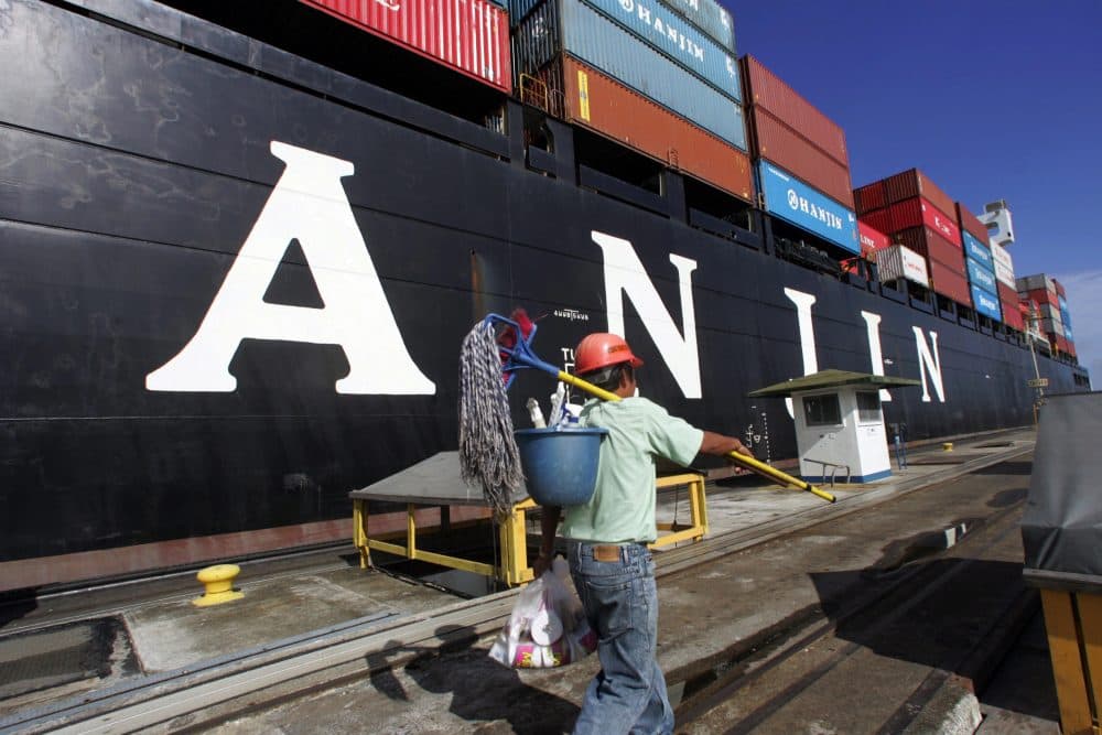 A worker walks next to a Hanjin cargo ship anchored in the Atlantic gate of the Panama Canal on Oct. 20, 2006. (Orlando Sierra/AFP/Getty Images)
