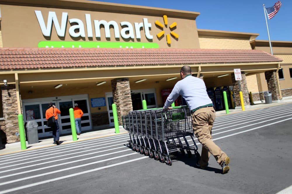Wal-Mart employee Yurdin Velazquez pushes grocery carts at a Walmart store on Feb. 19, 2015 in Miami. (Joe Raedle/Getty Images)