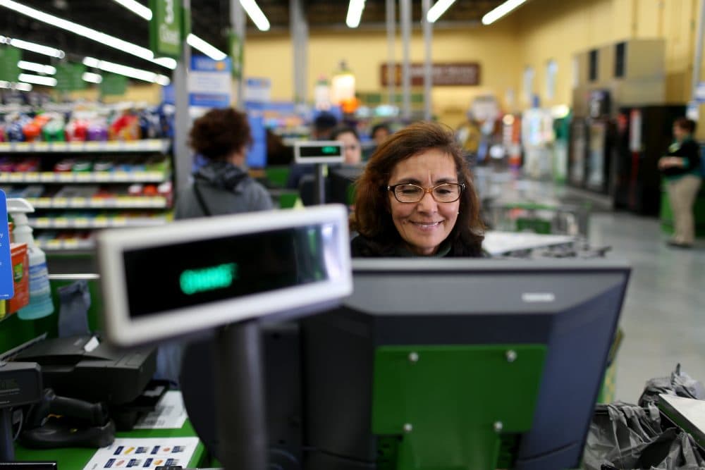 Wal-Mart employee Blanca Mojita rings up a customer's purchases at a Wal-Mart store on Feb. 19, 2015 in Miami. (Joe Raedle/Getty Images)