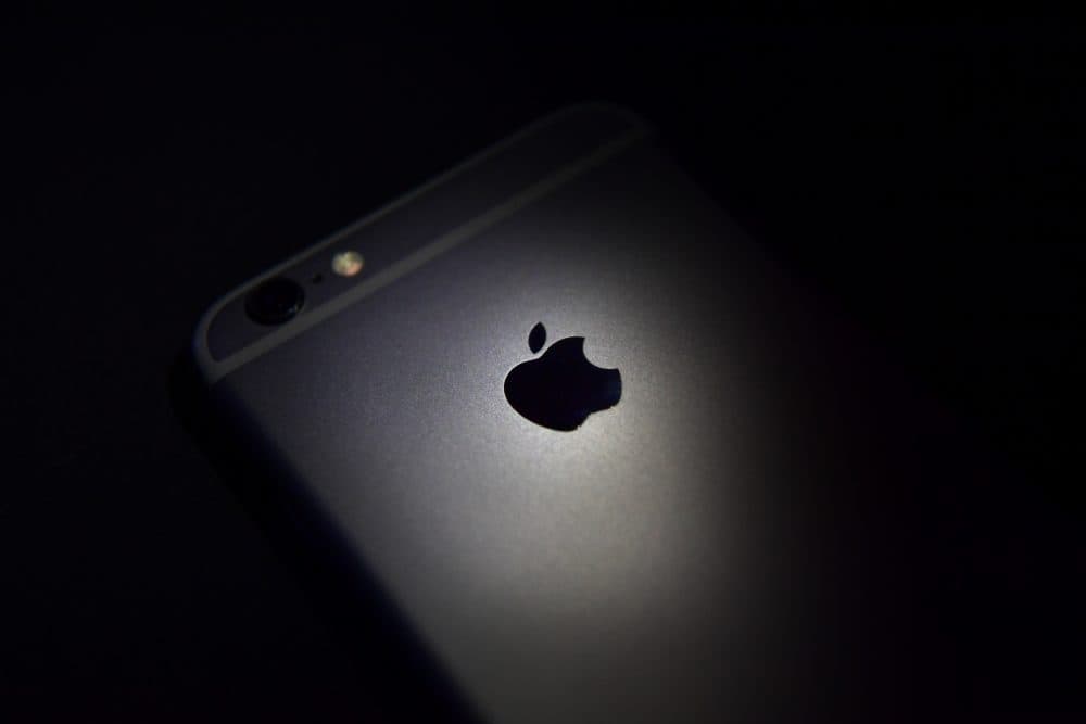 The Apple logo displayed on the back of an iPhone. (Carl Court/Getty Images)