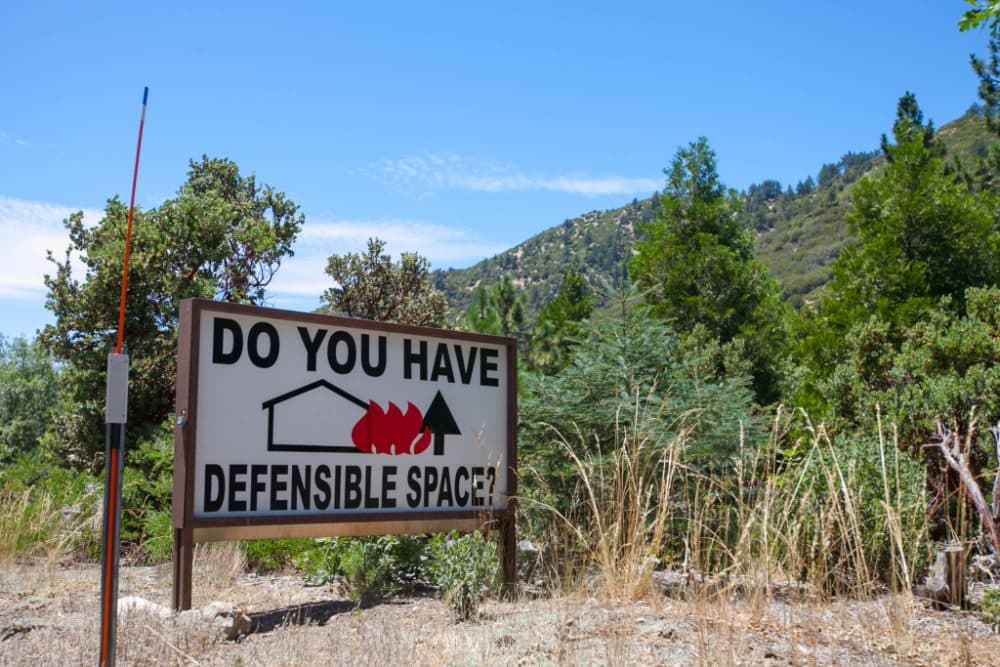 Property owners living close to wilderness areas must remain vigilant; embers can also travel large distances and ignite properties within housing tracts. (Susanica Tam for KPCC)