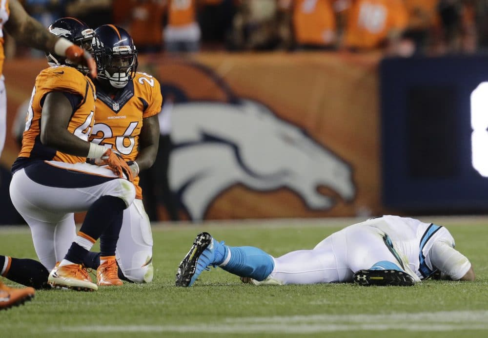 Cam Newton lies on the turf after a roughing the passer penalty on Denver Broncos free safety Darian Stewart. (AP/Joe Mahoney)