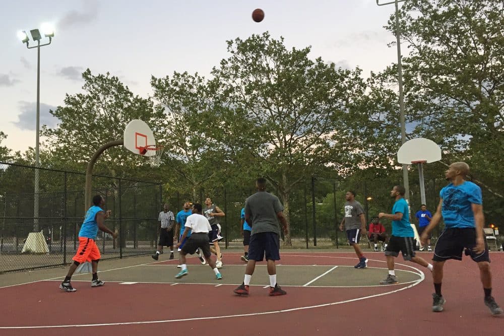 Young men gather to play basketball at the community center of the Hailey Apartments. (Delores Handy/WBUR)
