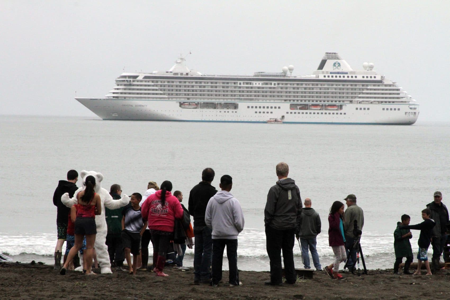 Onlookers prepare to take a polar plunge in the Bering Sea in front of the luxury cruise ship Crystal Serenity, which anchored just outside Nome, Alaska. The ship made a port call as it became the largest cruise ship to ever go through the Northwest Passage, en route to New York City. (Mark Thiessen/AP)