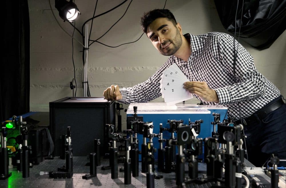 Barmak Heshmat poses with his prototype scanning device in an MIT lab in Cambridge. (Michael Dwyer/AP)