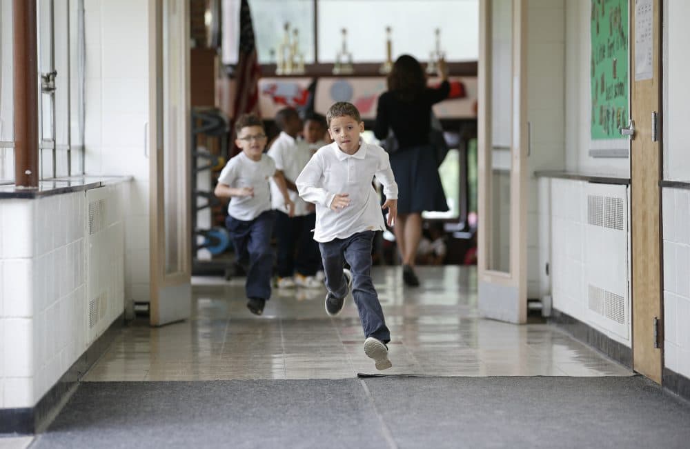 In this Tuesday, June 7, 2016 photo, students run to go outside at the start of a recess between classes at Little Fort Elementary school in Waukegan, Ill. (Kamil Krzaczynski/AP)

