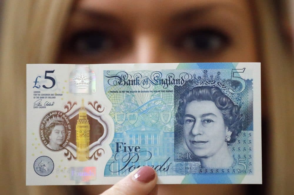 A Bank of England employee shows the new five pound note at the Bank of England Museum in London, Tuesday, Sept. 6, 2016. (Frank Augstein/AP)