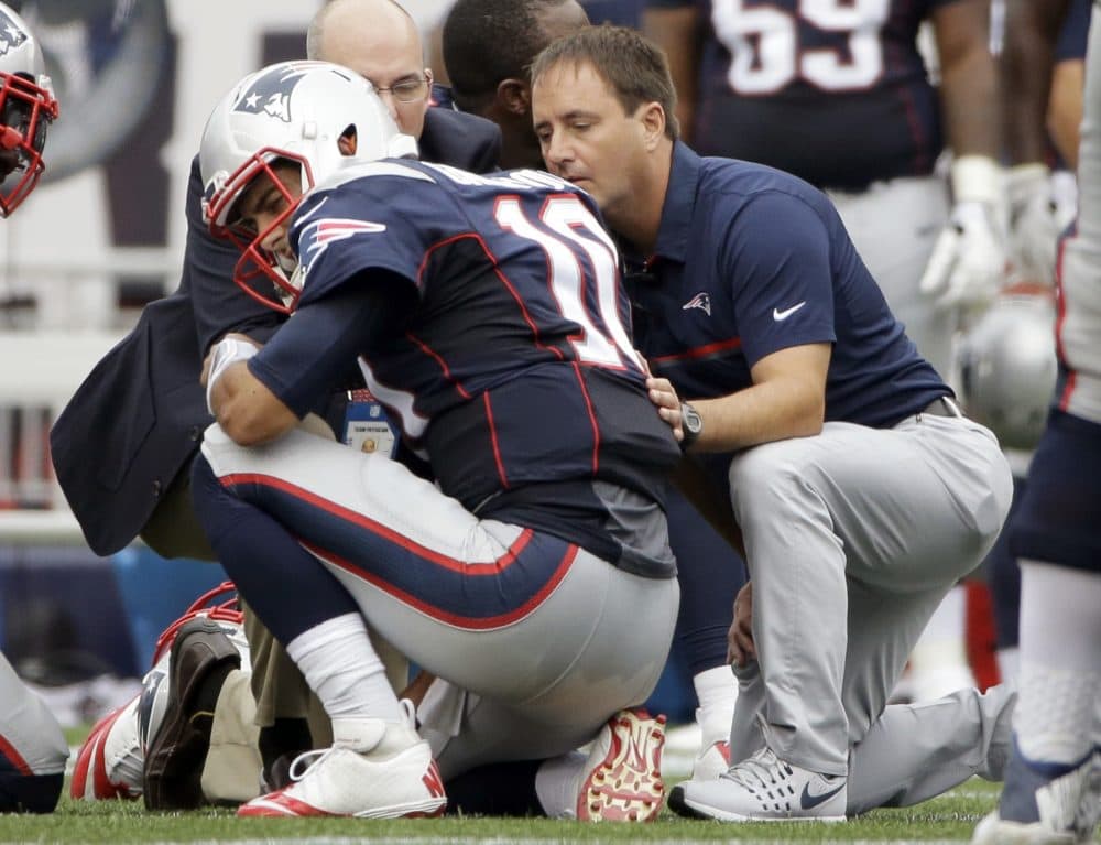 Quarterback Jimmy Garoppolo receives medical attention during the first half of Sunday's game against the Miami Dolphins. (Steven Senne/AP)