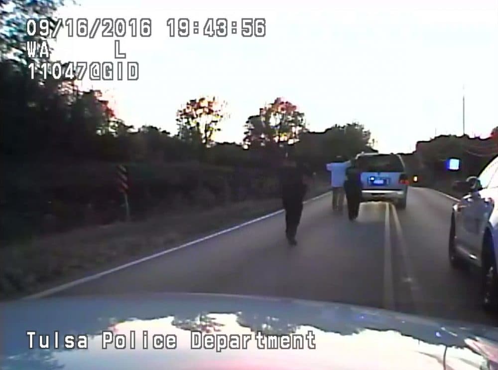 In this image made from a Friday, Sept. 16, 2016 police video, Terence Crutcher, center, is pursued by police officers as he walk to an SUV in Tulsa, Okla. Crutcher was taken to the hospital where he was pronounced dead after he was shot by the officer around 8 p.m., Friday, police said. (Tulsa Police Department via AP)