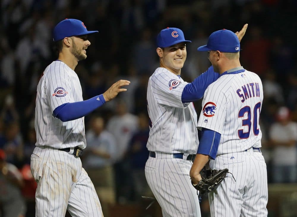 Kris Bryant (left), Anthony Rizzo (middle) and Joe Smith of the Chicago Cubs celebrate a win over the Cincinnati Reds at Wrigley Field on Sept. 21, 2016, in Chicago. (Jonathan Daniel/Getty Images)