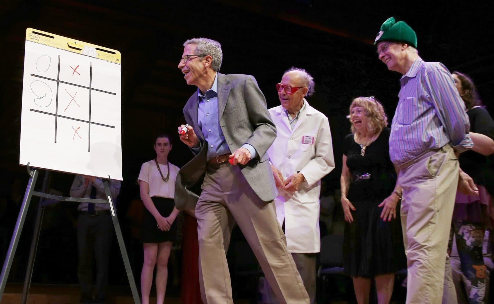 Nobel laureates Rich Roberts (physiology or medicine, 1993), right, Dudley Herschbach (chemistry, 1986) third from right, and Eric Maskin (economics, 2007), second from left, compete in a game of &quot;tic-toc-toe&quot; with a brain surgeon during the Ig Nobel award ceremonies. (Michael Dwyer/AP)