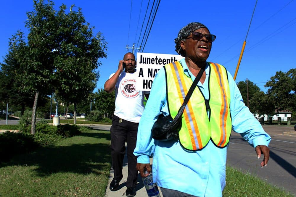 Opal Lee plans to turn 90 on her walk to the nation's capital. Behind her is Willie Johnson, principal of E.B. Comstock Middle School in Dallas, who joined her for a leg of the walk. (Christopher Connelly/KERA News)