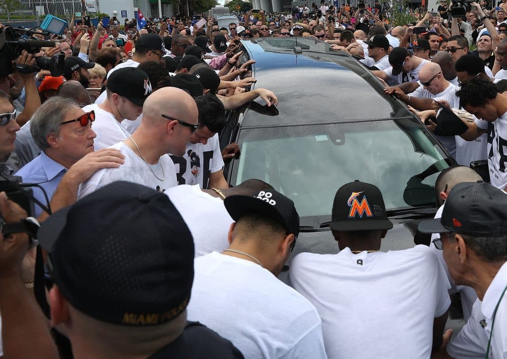 Miami Marlins owner, Jeffrey Loria (L), along with players and other members of the Marlins organization and their fans, gather next to the hearse carrying Marlins pitcher Jose Fernandez to pay their respects as they pass in front of Marlins Park on Sept. 28, 2016, in Miami. (Joe Raedle/Getty Images)
