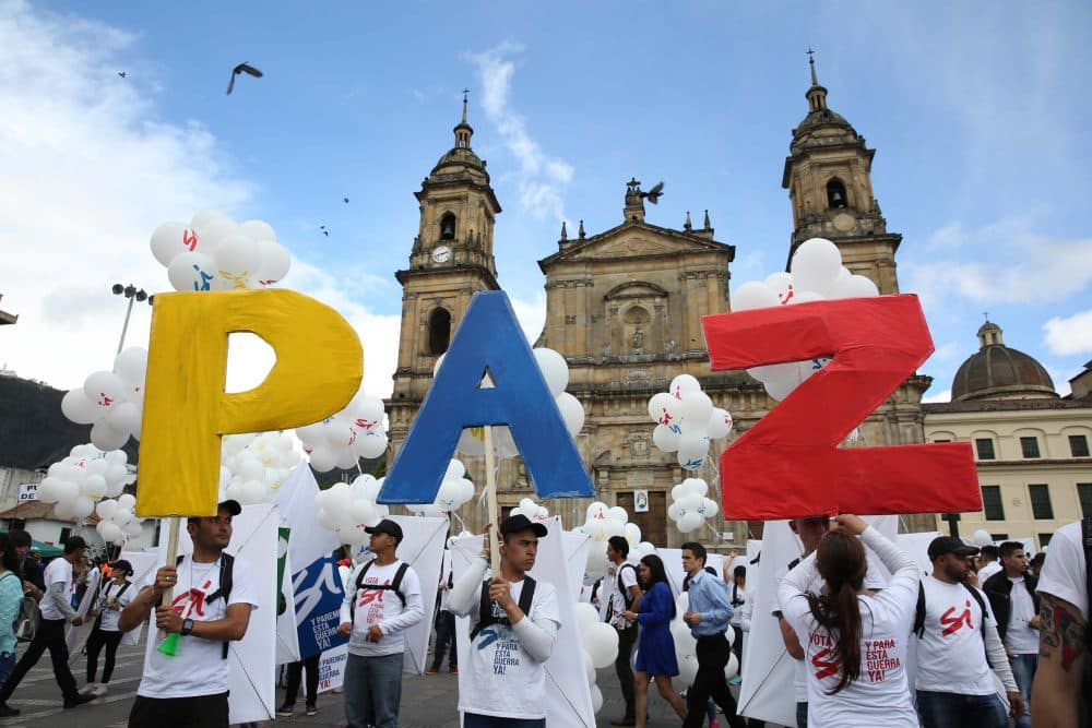 People hold up letters that form the word &quot;Peace&quot; in Spanish during a gathering at Bolivar square in Bogota, Colombia, Monday, Sept. 26, 2016. (Jennifer Alarcon/AP)