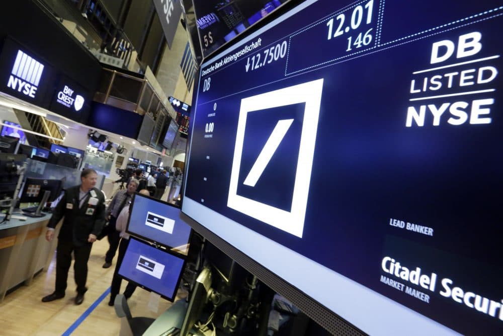 Shares in Deutsche Bank are down sharply after a report that the German government won't intervene with U.S. officials who are pressing the bank to pay $14 billion to settle an investigation into its sales of mortgage-backed securities. (Richard Drew/AP)