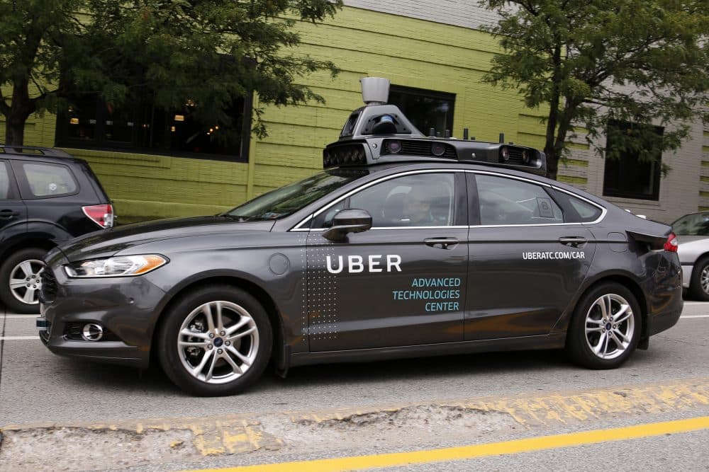 A self driving Uber car drives in Pittsburgh on Wednesday, Sept. 14, 2016. While the vehicles are loaded with features that allow them to navigate on their own, an Uber engineer sits in the driver's seat and can seize control if things go awry. (Gene J. Puskar/AP)
