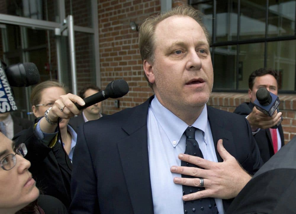 In this 2012 file photo, former Sox pitcher Curt Schilling is followed by members of the media as he departs the Rhode Island Economic Development Corporation headquarters in Providence. (Steven Senne/AP)