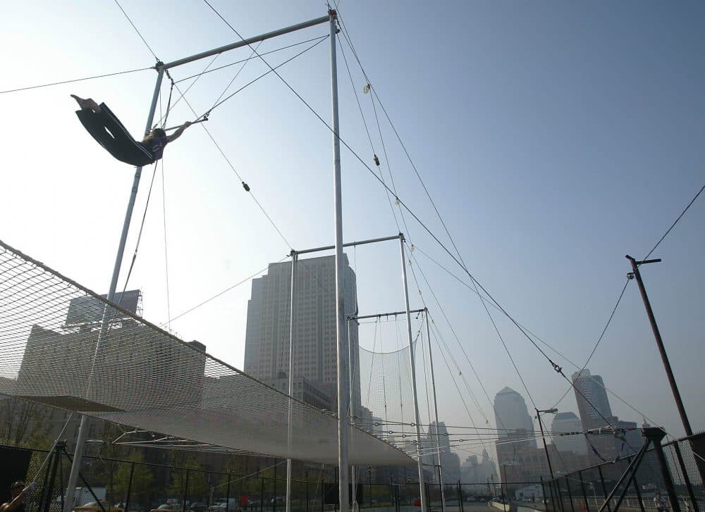 A student of the Trapeze School of New York sails through the air on Oct. 3, 2002, in downtown Manhattan in New York City. (Doug Kanter/AFP/Getty Images)