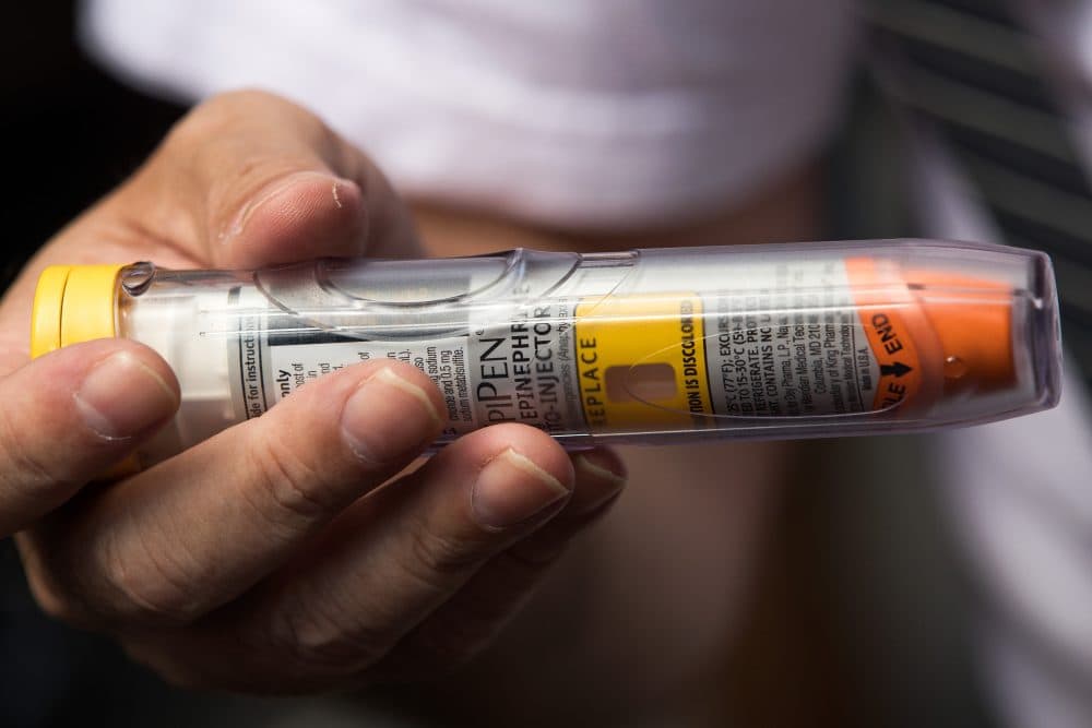 Timothy Lunceford Stevens, who suffers from autoimmune diseases and allergies, holds an EpiPen during a protest against its price hikes on Aug. 30, 2016 in New York City. (Drew Angerer/Getty Images)