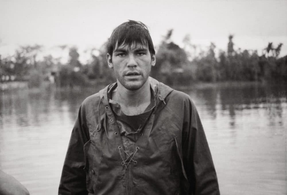 Soaking wet in a poncho, Stone is pictured coming off an APC (Armored Personnel Carrier) and crossing a river near a demilitarized zone in the First Cavalry Division, 1968. (Courtesy of Oliver Stone and Ixtlan Productions)