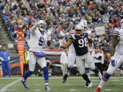 Buffalo Bills quarterback Tyrod Taylor (5) passes as New England Patriots defensive lineman Trey Flowers (98) closes in during the second half of an NFL football game Sunday in Foxborough, Mass. (Elise Amendola/AP)