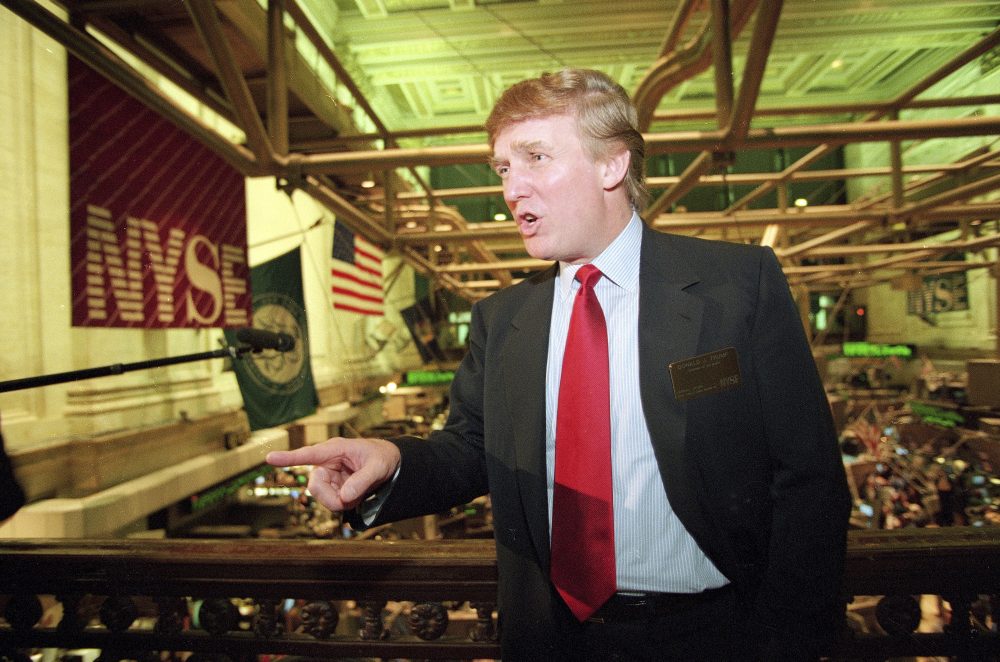 This June 7, 1995, file photo shows real estate magnate Donald Trump posing for photos above the floor of the New York Stock Exchange after taking his flagship Trump Plaza Casino public in New York City. Trump's business losses in 1995 were so large that they could have allowed him to avoid paying federal income taxes for as many as 18 years, according to records obtained by The New York Times. (Kathy Willens/AP)