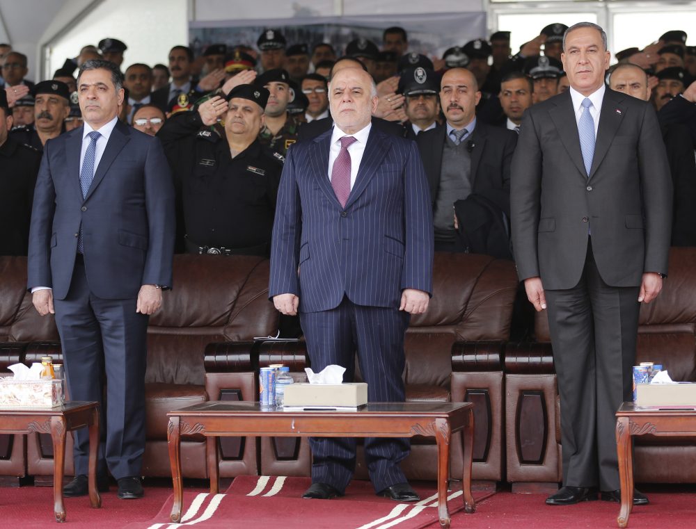 In this Jan. 9, 2016 file photo, Iraqi Prime Minister Haider al-Abadi, center, then Defense Minister Khaled al-Obeidi, right, and then Interior Minister Mohammed al-Ghabban, left, attend a ceremony marking Police Day, in Baghdad, Iraq. (Karim Kadim/AP)