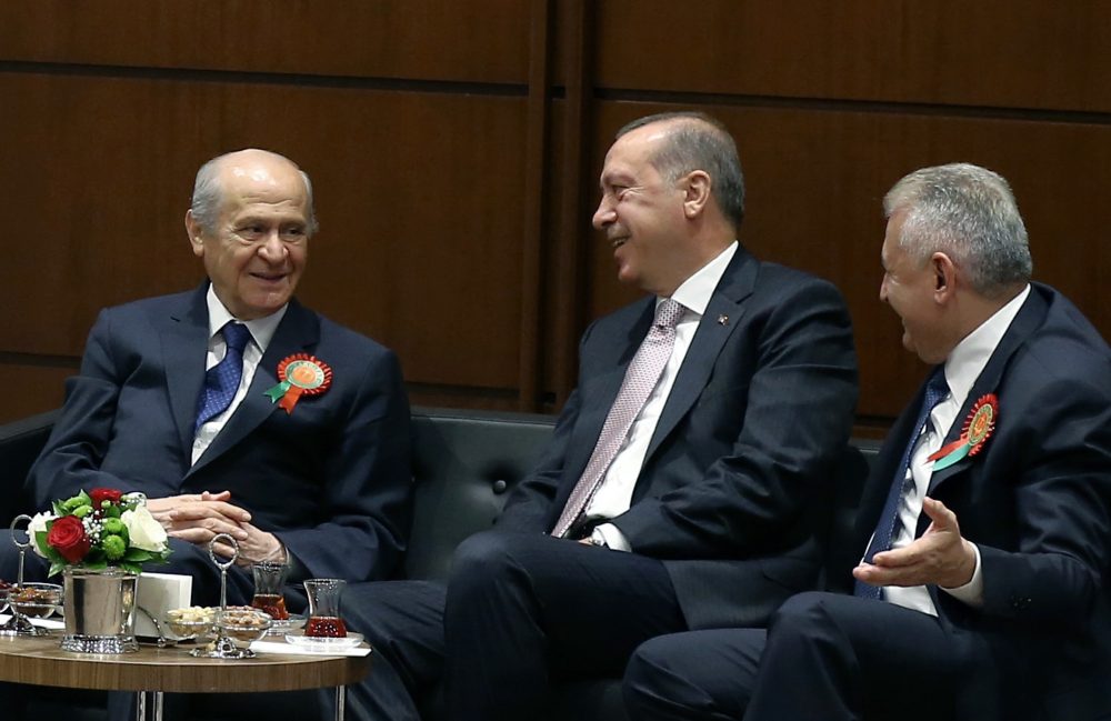 Turkey's President Recep Tayyip Erdogan, center, Prime Minister Binali Yildirim, right, and opposition Nationalist Movement Party leader Devlet Bahceli speak before Erdogan addresses a gathering of judges and lawyers at his palace in Ankara, Turkey on Sept. 1. (Yasin Bulbul, Presidential Press Service, Pool via AP)