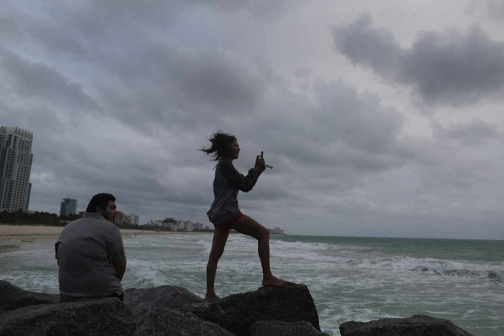 Gavin Cohen (left) and Ada Cohen take in the scene as Hurricane Matthew approaches the area on Oct. 6, 2016 in Miami Beach, Florida. (Joe Raedle/Getty Images)