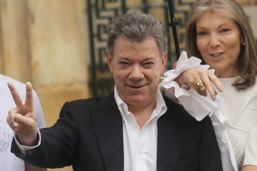 Colombia's President Juan Manuel Santos (center) makes the victory/peace sign with wife Maria Clemencia Rodriguez after voting in the referendum on a peace accord to end the 52-year-old guerrilla war between the FARC and the state on Oct. 2, 2016 in Bogota, Colombia. (Mario Tama/Getty Images)