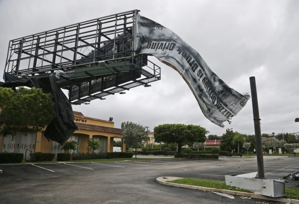 A billboard canvas flaps in the wind after Hurricane Matthew passed off shore, Friday, Oct. 7, 2016, in North Palm Beach, Fla. (Wilfredo Lee/AP)