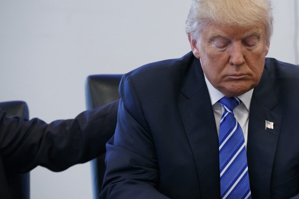 In this file photo, Republican presidential candidate Donald Trump pauses during a meeting with members of the National Border Patrol Council at Trump Tower in New York. A defiant Trump insists he will not abandon his White House bid amid growing backlash from Republican leaders after he was caught on tape bragging about predatory advances on women. (Evan Vucci/AP)